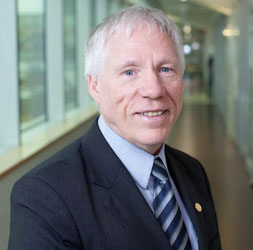 Portrait of a man in a hallway smiling